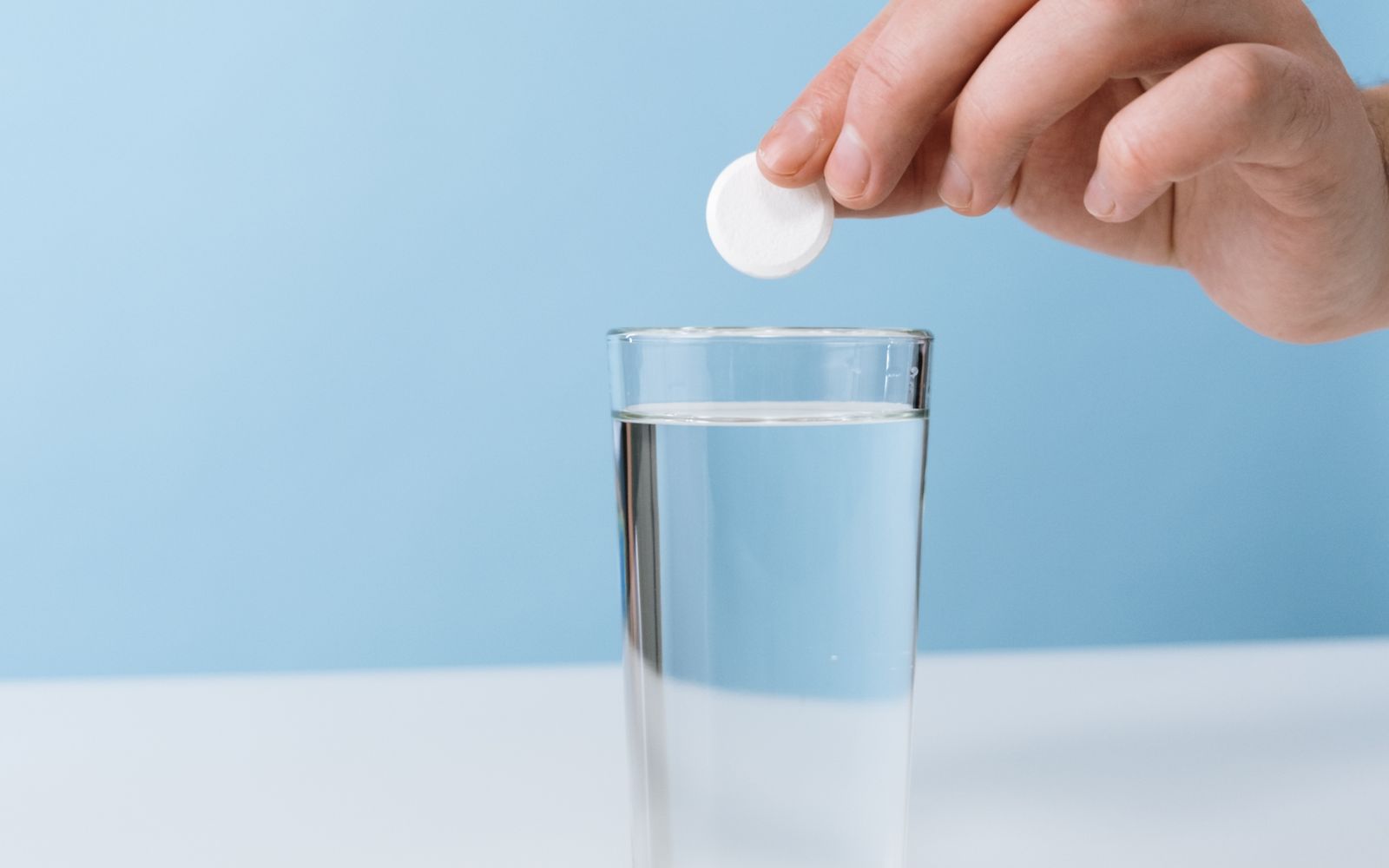 A magnesium tablet dropped into a glass of water before bed